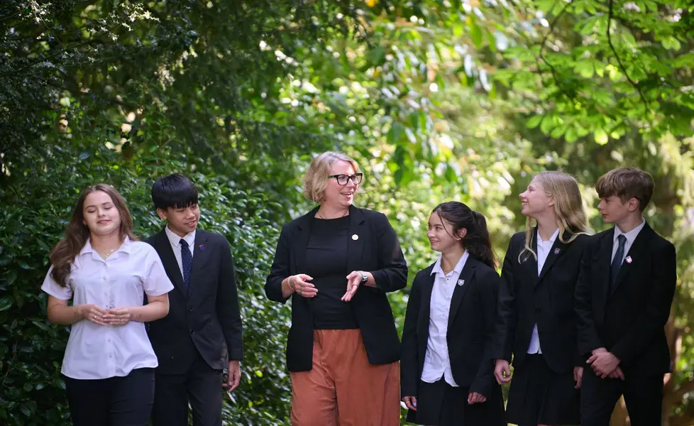 Teacher socialising with students outdoors